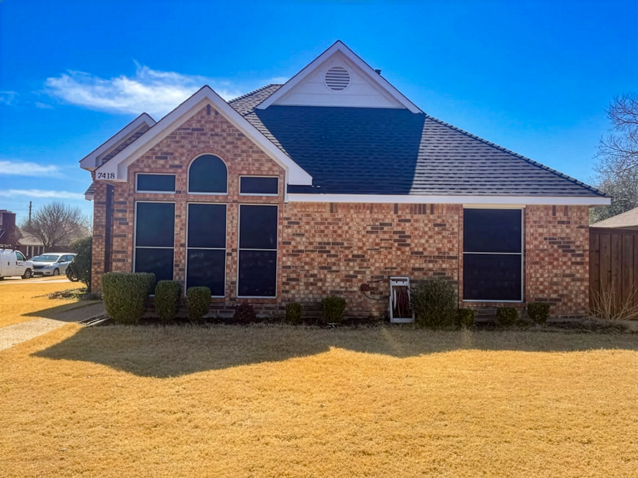 Brick home with completed slate roof installation