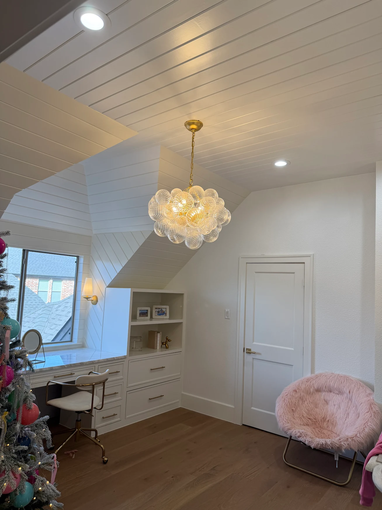 Vaulted shiplap ceiling with designer chandelier