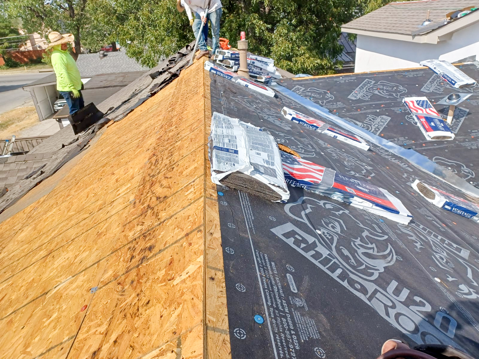 WAS Construction crew installing premium Rhino underlayment on a DFW home roof