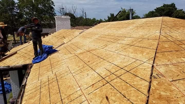 Completed exterior renovation — painted brick home with new dark shingle roof